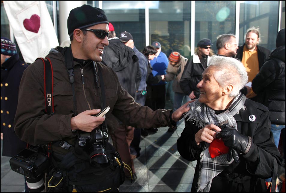 Josh Trujillo is introduced to Dorli Rainey after a press conference on the steps of the Seattle Police Department. Photo by Ted S. Warren, Associated Press